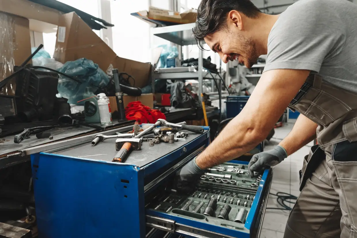 Heavy duty diesel technician in professional shop environment with diagnostic and repair equipment